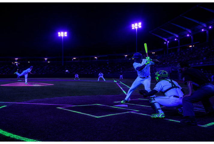 Night game under UV-A floodlights with fluorescent field markings